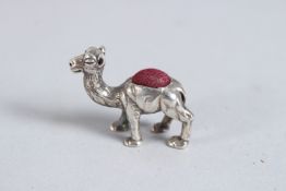 A SILVER CAMEL PIN CUSHION.