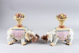 A PAIR OF PORCELAIN AND FLOWER ELEPHANTS. 10ins high.