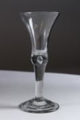 A LARGE GEORGIAN WINE GLASS with plain bowl and stem with teardrop. 7.5ins high.