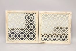 A PAIR OF WHITE GARDEN MIRRORS.