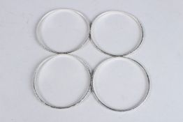 A STERLING SILVER FOUR STRAND MULTI BANGLE.