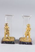 A GOOD PAIR OF GILT BRONZE AND GLASS SPILL VASES with cupids and Blue John bases. 9ins high.