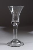 A GEORGIAN WINE GLASS with inverted bell bowl and plain stem. 6ins high.