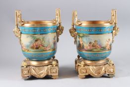 A GOOD PAIR OF SEVRES DESIGN TWO-HANDLED CACHE POTS, blue ground painted with cupids, with gilt