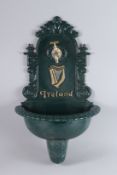 A BLACK PAINTED IRISH CAST IRON WALL FOUNTAIN. 28ins high.