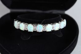 A SILVER OPAL AND CZ BANGLE.