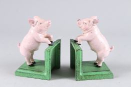 A PAIR OF SMALL PAINTED CAST IRON PIG BOOKENDS. 5.5ins high.