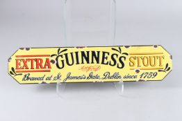 AN ENAMEL GUINNESS SIGN. 5ins x 22ins.