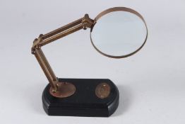 A REPLICA MAGNIFYING GLASS on a stand.