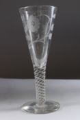 A LARGE WINE GLASS, the tapering bowl engraved with roses with twist stem. 12ins high.