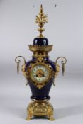 A GOOD SEVRES BLUE PORCELAIN AND ORMOLU LAMP, with mask handle, on claw feet. 26ins high.