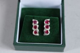 A PAIR OF SILVER, RUBY AND DIAMOND EARRINGS.