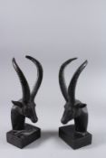 A PAIR OF BRONZE ANTELOPE HEAD BOOKENDS on marble bases. 13ins.