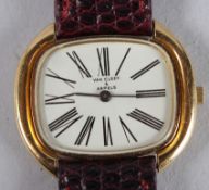 A LADIES' VAN CLEEF & ARPELS WRISTWATCH with a leather strap.