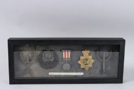 THE MEDALS, BADGES AND SPURS OF CAPT. E. J. UPTON, 72nd HIGHLANDERS AND 26 FOOT, in a glass case.