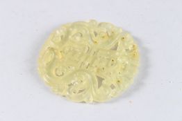 A CHINESE CARVED JADE ROUNDEL.