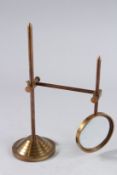 A REPLICA MAGNIFYING GLASS on a stand.