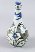 A PERSIAN BOTTLE VASE painted with deer and flowers. 10ins high.