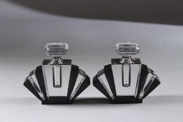 A SMALL PAIR OF BLACK ART DECO DESIGN SCENT BOTTLES AND STOPPERS. 3.5ins high.