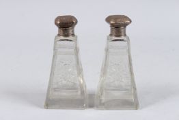 A PAIR OF ENGRAVED GLASS SCENT BOTTLES.