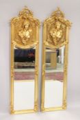 A PAIR OF LOUIS XVI STYLE LONG NARROW MIRRORS with portraits of ladies in relief. 5ft 10ins x 1ft