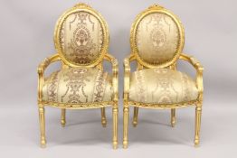 A GOOD PAIR OF LOUIS XVI GILTWOOD ARMCHAIRS with padded oval backs and seats.