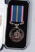 A CASED NATIONAL SERVICE MEDAL, No. 98713.