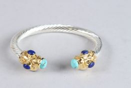 A STERLING SILVER, LAPIS AND TURQUOISE TWISTED TORQUE STYLE BANGLE.