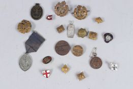 A BAG OF VARIOUS METAL BADGES.
