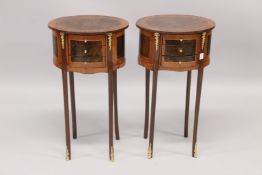 A PAIR OF LOUIS XVI STYLE OVAL CROSSBANDED BEDSIDE TABLES with three drawers, on four curving