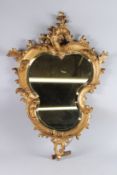 A GOOD 19TH CENTURY ITALIAN GILTWOOD SHAPED MIRROR with acanthus scrolls. 2ft 8ins long x 1ft 8ins