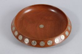 A CIRCULAR WOODEN BOWL. 12ins diameter, inset with 1935 - 1959.