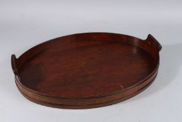 A GEORGE III MAHOGANY OVAL BRASS BOUND TWO HANDLED TEA TRAY. 20ins long.