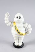 A PAINTED CAST IRON MICHELIN MAN BANK. 9ins high.