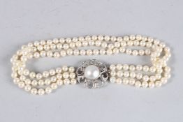 A GOOD PEARL TRIPLE ROW CHOKER with 18ct white gold and diamond clasp.