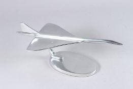 A CHROME MODEL OF CONCORDE on an oval base. 16.5ins long.