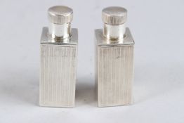 A PAIR OF WHITE METAL SQUARE SCENT BOTTLES.