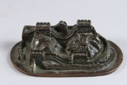 A MINIATURE BRONZE VILLAGE. 4ins.