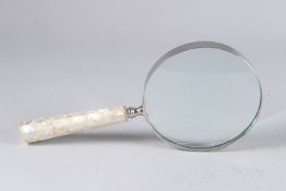 A LARGE MOTHER-OF-PEARL MAGNIFYING GLASS.