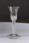A GEORGIAN WINE GLASS with inverted bell bowl, with air twist stem. 6ins high.