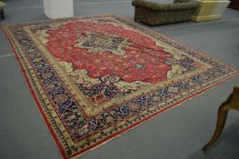 A VERY LARGE PERSIAN CARPET with allover floral motifs, in mainly red and blue. 14ft 2ins x 11ft.