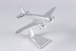 A SMALL CHROME DAKOTA on a stand. 5ins high.