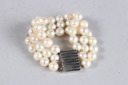 A GOOD PEARL TRIPLE ROW BRACELET with 18ct white gold clasp.