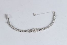 A 14CT WHITE GOLD AND DIAMOND BANGLE.