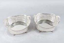 A PAIR OF SILVER PLATE CHERUB SHELL SALTS.