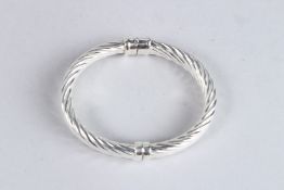 A STERLING SILVER HINGED BANGLE.