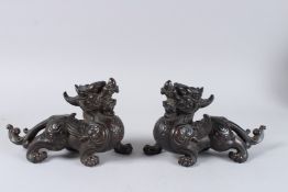 A GOOD PAIR OF BRONZE FOO DOGS. 9.5ins high.