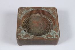 A CHINESE BRONZE RICE CAKE MOULD. 3.25ins x 3.25ins.
