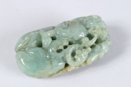 A CHINESE CARVED JADE STONE, carved and pierced with dragons. 3ins.