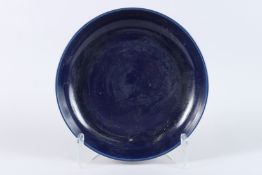 A LARGE CHINESE BLUE GROUND PORCELAIN DISH. 33cms diameter.